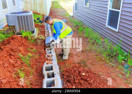 Constructing retaining walls that are being installed by contractor Stock Photo
