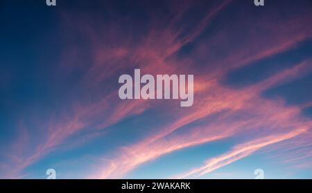 Colorful fluffy striped cloud and blue sky in twilight sunset Stock Photo