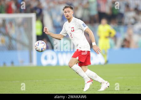 Matty Cash of Poland seen in action during the FIFA World Cup Qatar 2022 match between Poland and Argentina at Stadium 974. Final score; Poland 0:2 Argentina. Stock Photo