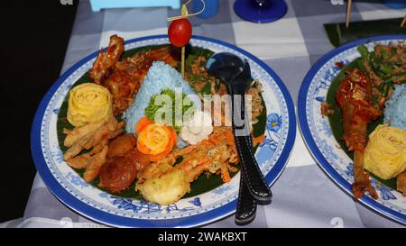 Rice in a cone shape or called Nasi Tumpeng A festive Indonesian rice dish with side dishes Stock Photo