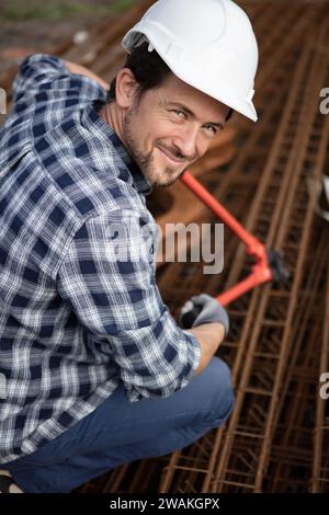 authentic construction worker cutting steel reinforcement bars Stock Photo