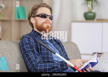 blind man reading braille at home Stock Photo
