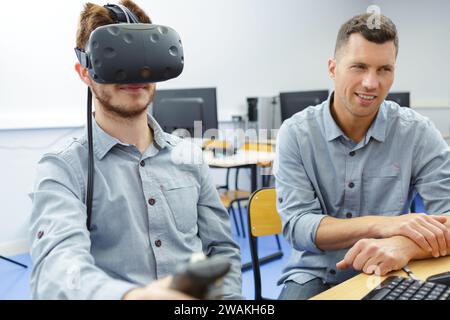 young man in technology lab using virtual reality headset Stock Photo