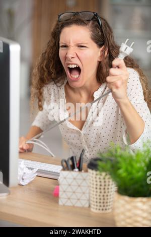 Worried secretary using a computer against a white background Stock ...