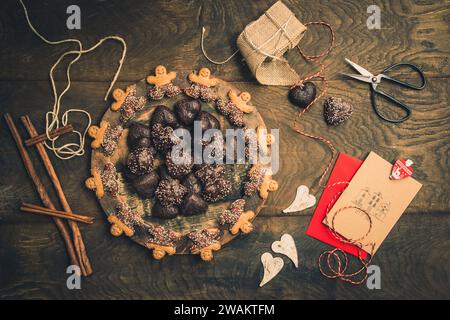 Scene for gifts in Advent with cookies, gift ribbon and card for text on dark wooden back ground, christmas concept. copy space, top view Stock Photo