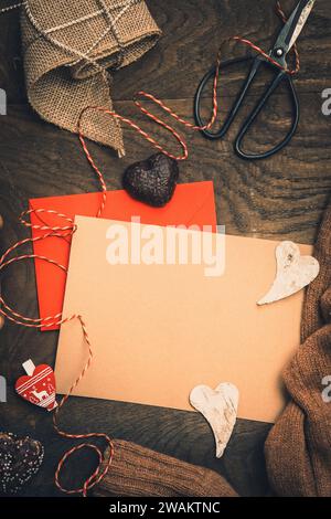 Scene for gifts in Advent with cookies, gift ribbon and card for text on dark wooden back ground, christmas concept. copy space, top view, vertical Stock Photo