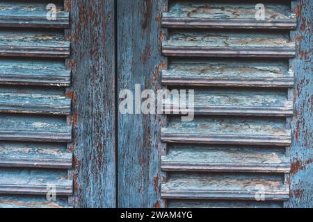 Closeup of old wooden window shutters in light blue color, vintage style, background, wallpaper Stock Photo
