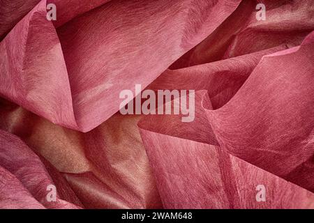 A background of crumpled pink wrapping paper. Close up. Stock Photo