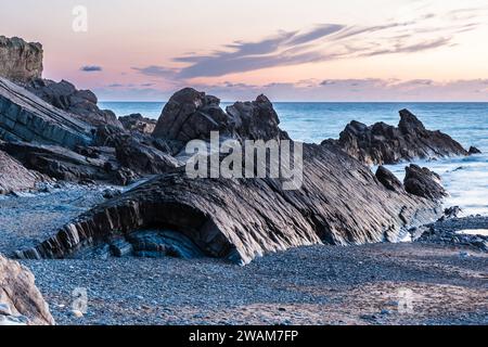 Rock formations on the north coast of Cornwall in the evening light after sunset, beutiful sky Stock Photo
