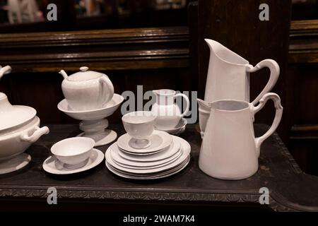 A wide variety of white plates bowls and mugs lined up Stock Photo