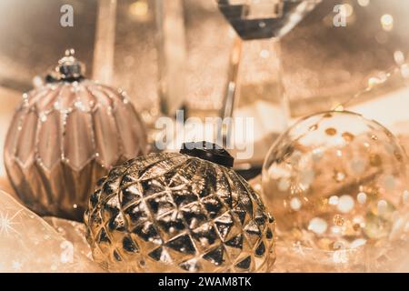 Close-up of Christmas baubles on a table decorated for Christmas, warm gold colors Stock Photo