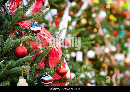 Christmas holiday background with a fir tree decorated in patriotic red, white and blue with blurred background. Stock Photo