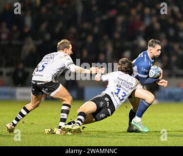 Joe Carpenter of Sale Sharks get tackled, by Benhard Janse van Rensburg of Bristol Bears  during the Gallagher Premiership match Sale Sharks vs Bristol Bears at AJ Bell Stadium, Eccles, United Kingdom, 5th January 2024  (Photo by Cody Froggatt/News Images) Stock Photo