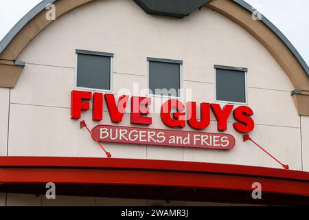Monroe, WA, USA - January 3, 2024; Sign on Five Guys burger and fries restaurant above red awning Stock Photo