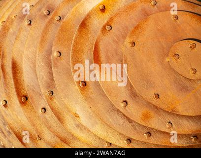 Rusted, screwed iron plates and shadows in sunlight Stock Photo