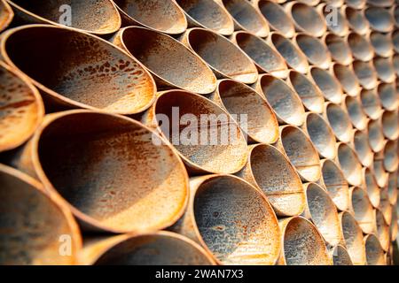 Rusty iron, Symmetrical metal pipes under the sun, with light shadow Stock Photo