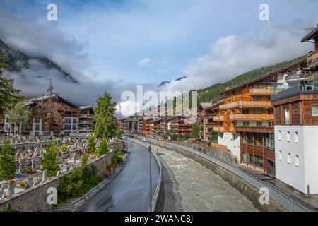 A canal controls the flow if the Matter Vispa river in Zermatt Switzerland Stock Photo
