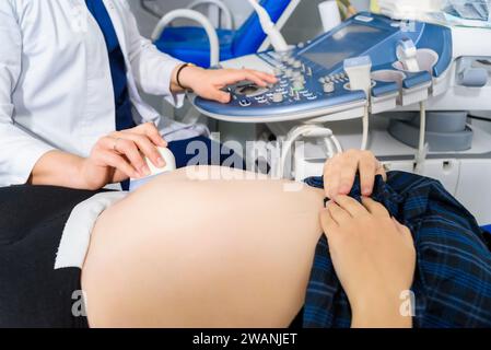 Doctor performing ultrasound on pregnant woman Stock Photo