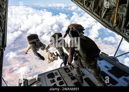 Djibouti. 27th Dec, 2023. U.S. Air Force operators assigned to the 82nd Expeditionary Rescue Squadron and Joint Personnel Recovery Center perform High Altitude, Low Opening (HALO) training jumps from a U.S. Marine Corps KC-130J Hercules cargo aircraft over East Africa, December. 27, 2023. HALO jumps are performed from altitudes where oxygen is limited, requiring members to employ specialized training beyond standard parachute insertions. (Credit Image: © Allison Payne/U.S. Air Force/ZUMA Press Wire) EDITORIAL USAGE ONLY! Not for Commercial USAGE! Stock Photo