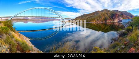 Roosevelt Bridge And Hydroelectric Dam Reflected in Apache Trail Lake Calm Water.  Scenic Superstition Mountains Panoramic Landscape View, Arizona USA Stock Photo