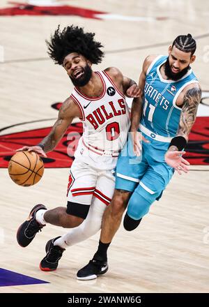 Chicago, USA. 5th Jan, 2024. Chicago Bulls guard Coby White (L) collides with Charlotte Hornets forward Cody Martin during the NBA regular season game between Chicago Bulls and Charlotte Hornets in Chicago, the United States, Jan. 5, 2024. Credit: Joel Lerner/Xinhua/Alamy Live News Stock Photo