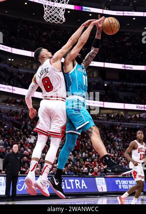 Chicago, USA. 5th Jan, 2024. Chicago Bulls guard Zach LaVine (L) and Charlotte Hornets forward Cody Martin vie for a rebound during the NBA regular season game between Chicago Bulls and Charlotte Hornets in Chicago, the United States, Jan. 5, 2024. Credit: Joel Lerner/Xinhua/Alamy Live News Stock Photo