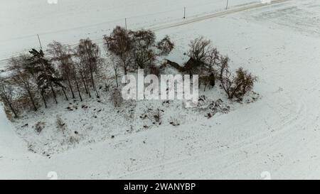 Drone photography of old abandoned wooden house in a rural landscape during winter cloudy day Stock Photo