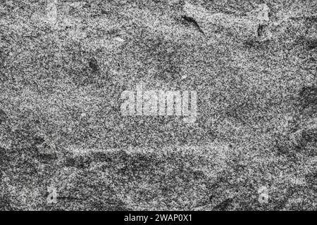uneven wall surface. Dark gray granite stone background texture surface. Stock Photo