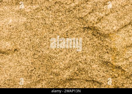 Yellow stone background. Toned stone texture. Embossed surface for design. Stock Photo