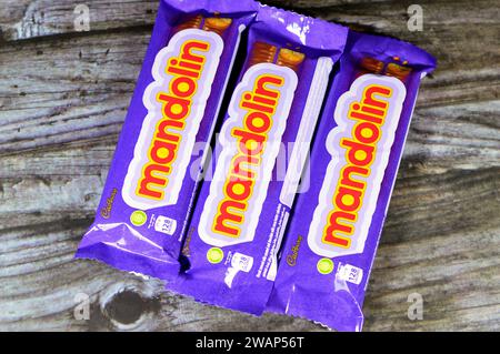 Cairo, Egypt, January 1 2024: Mandolin Biscuit Covered with Caramel and Chocolate, Cadbury Mandolin bars with Ingredients of Stock Photo