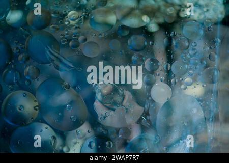 Abstract oil in water using natural light in blue tones. Good for wallpaper or background Stock Photo