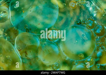 Abstract oil in water using natural light in blue and green tones. Good for wallpaper or background Stock Photo