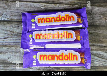 Cairo, Egypt, January 1 2024: Mandolin Biscuit Covered with Caramel and Chocolate, Cadbury Mandolin bars with Ingredients of Stock Photo