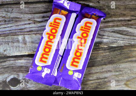 Cairo, Egypt, January 1 2024: Mandolin Biscuit Covered with Caramel and Chocolate, Cadbury Mandolin bars with Ingredients of Stock Photo
