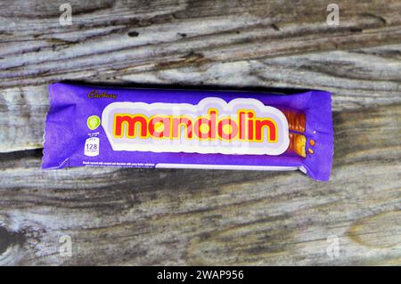 Cairo, Egypt, January 1 2024: Mandolin Biscuit Covered with Caramel and Chocolate, Cadbury Mandolin bars with Ingredients of Stock Photo