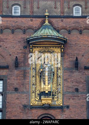 The gilded copper statue of Bishop Absalon (the founder of Copenhagen) on the Copenhagen City Hall in Copenhagen, Denmark. Stock Photo