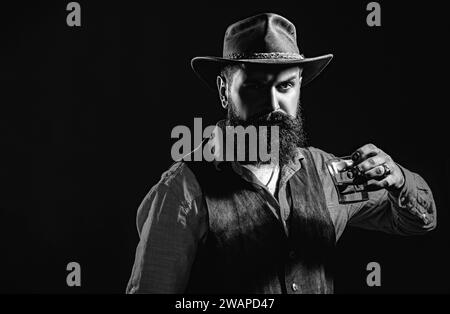 Bartender holding glass of whisky. Tasting and degustation concept. Retro vintage man with whiskey or scotch. Bartender leather apron holding whisky Stock Photo
