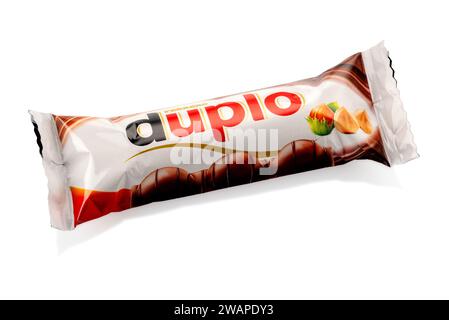 Alba, Italy - January 04, 2023: Duplo Ferrero snack with three whole hazelnuts in cocoa filling with chocolate-covered wafer, isolated package on whit Stock Photo