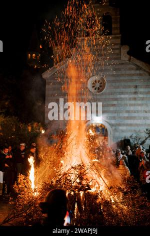 Budva, Montenegro - 06 january 2024: Orthodox Christmas Eve Ritual with Oak Fire in Montenegro Stock Photo