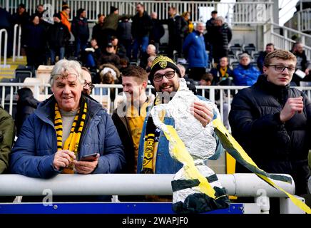 A Maidstone United fan holds up a replica of the Emirates FA Cup trophy ahead of the Emirates FA Cup Third Round match at the Gallagher Stadium, Maidstone. Picture date: Saturday January 6, 2024. Stock Photo