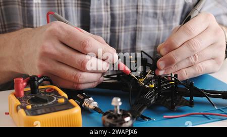 Masrter Cheching Circuit Connection On Microchip Board In Service Center, Hobby FPV Drone Assembling Process Stock Photo