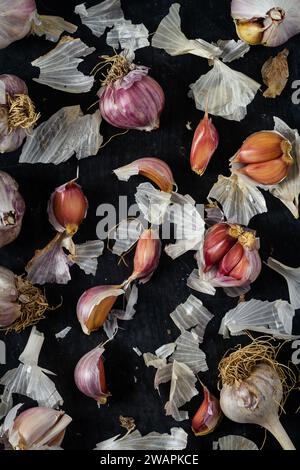 Fresh garlic bulbs and cloves grouped on black background. Flat lay ...