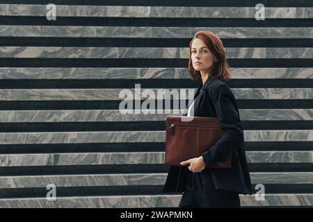 Side View of a Black Businesswoman walking in side view isolated on a ...