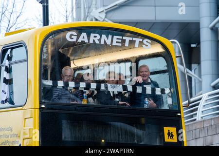 Newcastle upon Tyne, UK. 6th January 2024. Newcastle United fans on the bus to take them to the away match in Sunderland, in the Wear-Tyne derby FA Cup 3rd Round. Credit: Hazel Plater/Alamy Live News Stock Photo