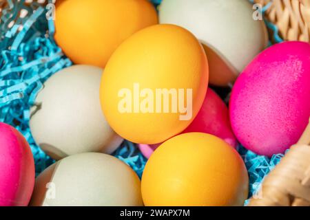 Close up multi colors Easter eggs in the woven basket Stock Photo