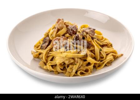 Egg noodles pasta with mushroom sauce, mushroom tagliatelle in white dish isolated on white with clipping path included Stock Photo
