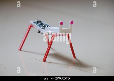 Small sized robot with four legs made using 3d printing technology and works with the help of vibration caused by small motor placed inside Stock Photo