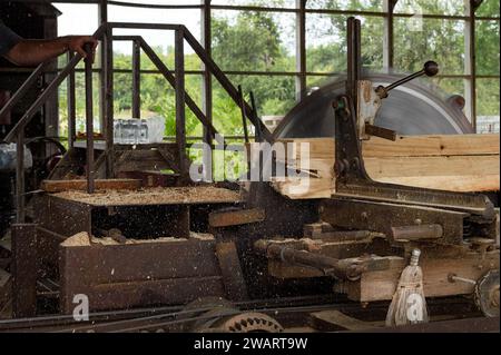 Steam Powered Sawmill Saws Through Wood Making Sawdust Fly - vintage Stock Photo