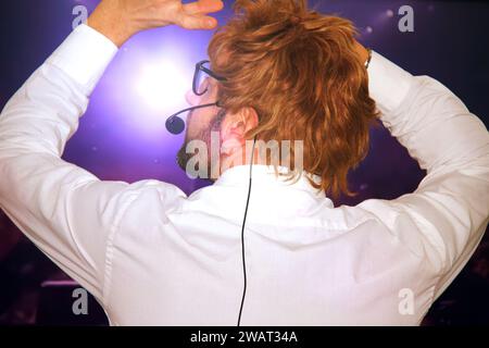 Famous Entertainer Gets on the Stage, Greets Audience, Starts Performance. Software Company Founder, Tech Marketing Guru Making a Pitch, Presentation Stock Photo
