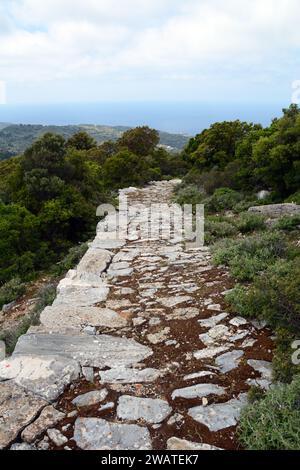 A hiking trail in the hills overlooking the Aegean Sea, on the north coast of the Greek Island of Ikaria, near Evdilos, Greece. Stock Photo